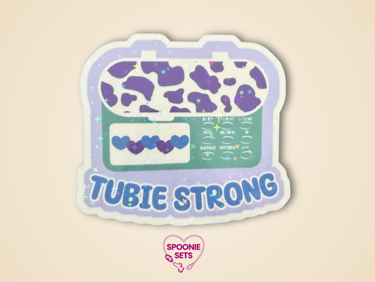 Sticker of a purple and green feeding tube pump with 'Tubie Strong' text