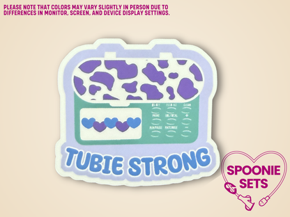 Sticker of a green and purple glossy feeding tube pump sticker with the text "Tubie Strong"