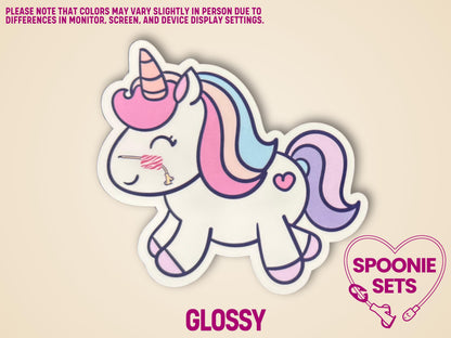 White unicorn sticker with pink, purple, and blue mane/tail, a striped horn, and a nasal feeding tube.