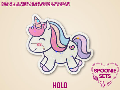 Holographic unicorn sticker with a nasal feeding tube, pink mane, and glitter laminate finish.