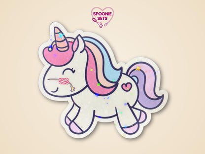 Holographic glitter unicorn sticker with a pink NG tube, pastel mane/tail, and heart detail.