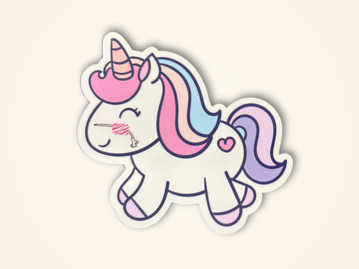 A sticker featuring a cute, smiling cartoon unicorn with a pastel rainbow mane and tail, pink horn and hooves, and a small heart on its side, shown on a light cream background.