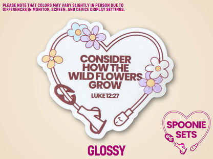 Heart-shaped sticker with a feeding tube design, wildflowers, and "Consider How The Wild Flowers Grow Luke 12:27" text.