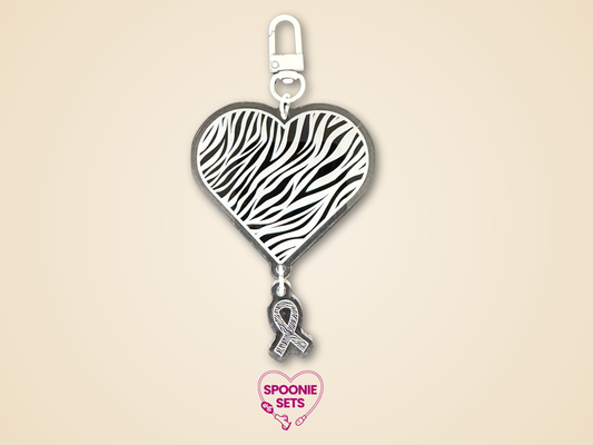 2.5-inch clear acrylic zebra print heart keychain with a small zebra print awareness ribbon charm.