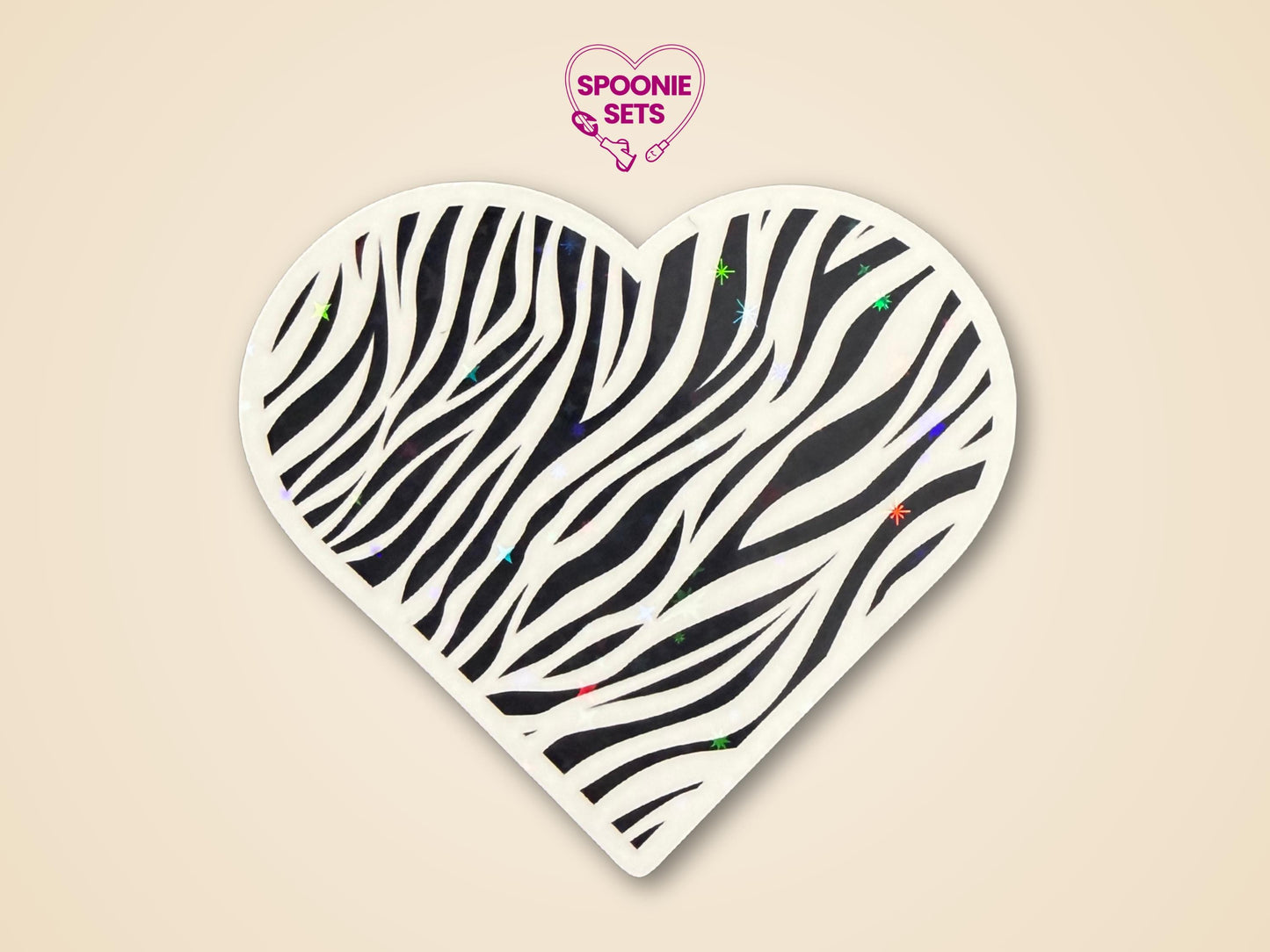 Heart-shaped zebra print sticker with black stripes and subtle holographic glitter, promoting rare disease awareness.
