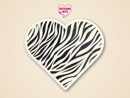 Heart-shaped zebra print sticker with black stripes and subtle holographic glitter, promoting rare disease awareness.